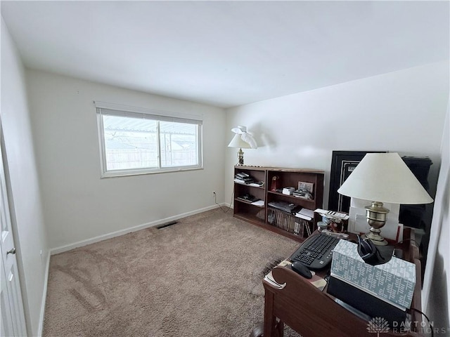 office with visible vents, baseboards, and carpet