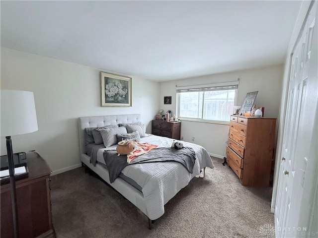 bedroom with light colored carpet and baseboards