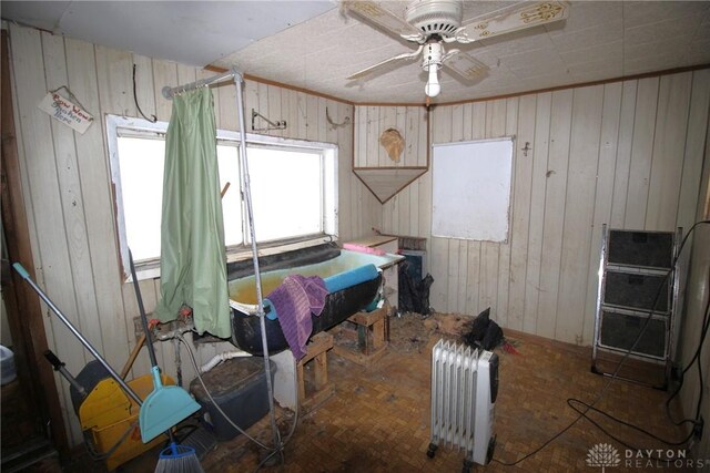 miscellaneous room with ceiling fan and radiator heating unit