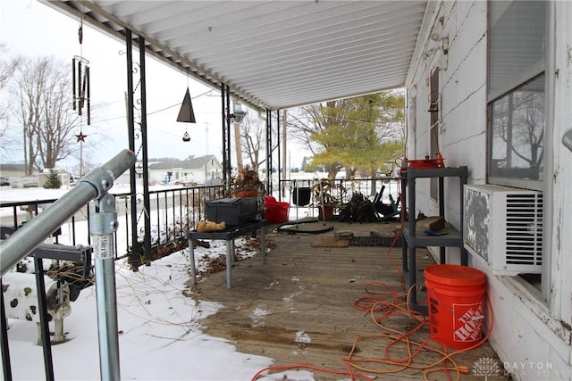 snow covered deck featuring cooling unit