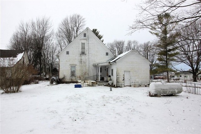 view of snow covered rear of property