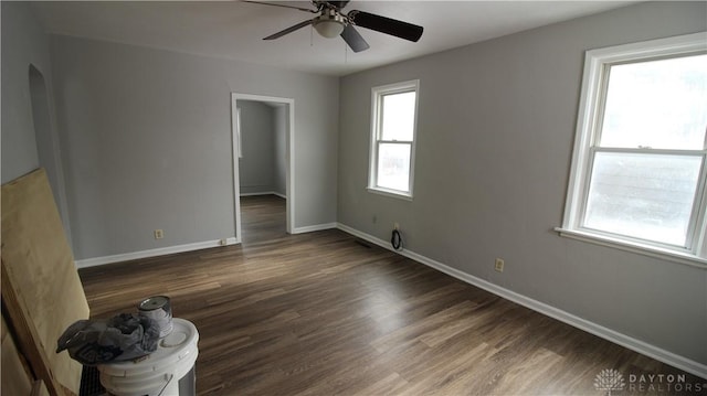 spare room with ceiling fan and dark hardwood / wood-style flooring