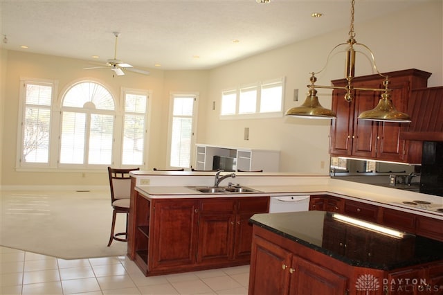 kitchen with ceiling fan, white appliances, sink, and a kitchen island