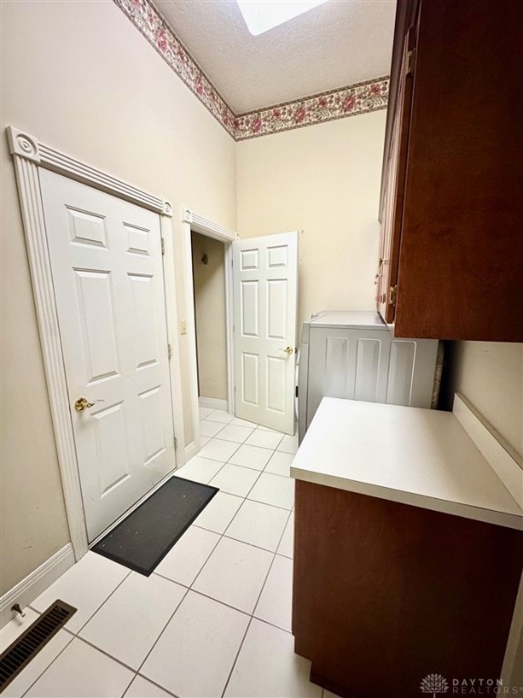 bathroom with tile patterned floors and a textured ceiling