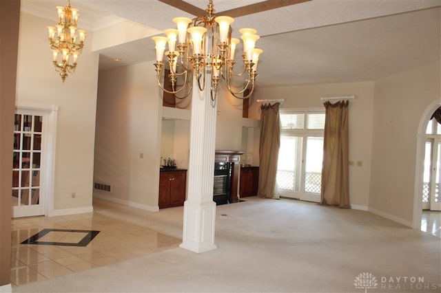 interior space featuring crown molding, a chandelier, and light tile patterned floors