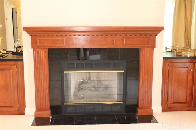 interior details with a tile fireplace