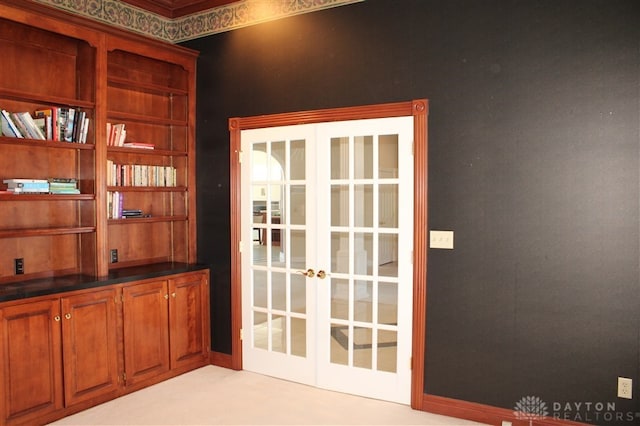 doorway to outside with light colored carpet and french doors