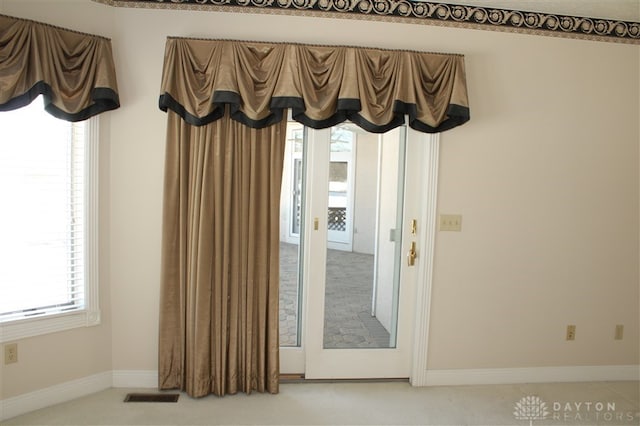 doorway to outside featuring carpet floors