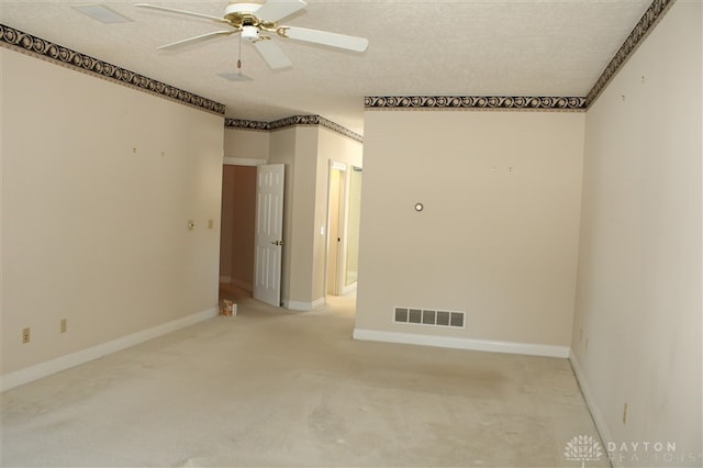 empty room with a textured ceiling, ceiling fan, and carpet flooring