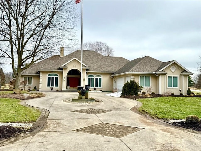 ranch-style home with a garage and a front yard