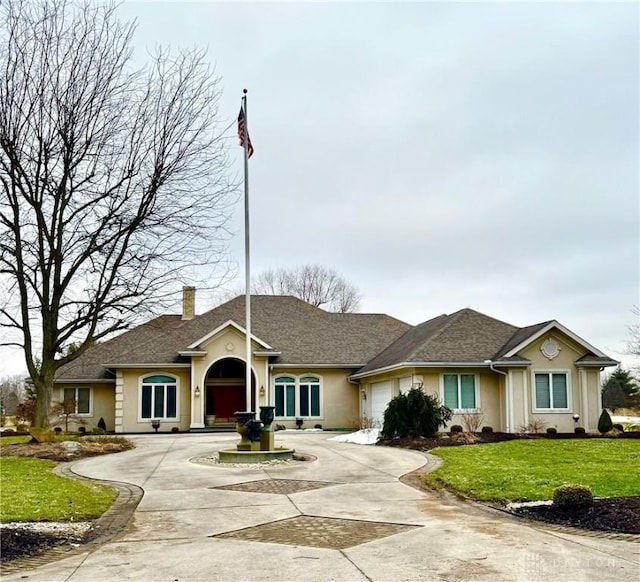 ranch-style home with a garage and a front yard