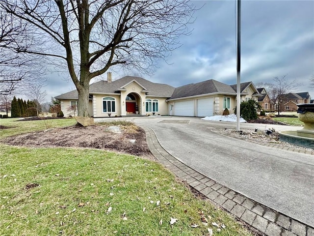 single story home with a garage and a front lawn