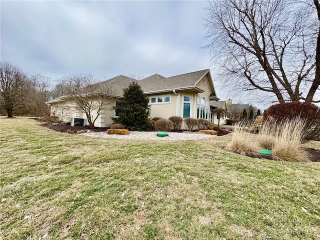 view of side of home with a lawn