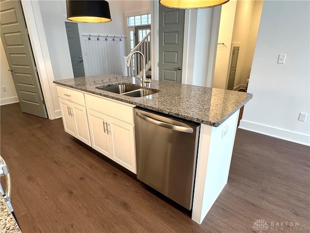 kitchen with dishwasher, white cabinetry, sink, a kitchen island with sink, and stone counters