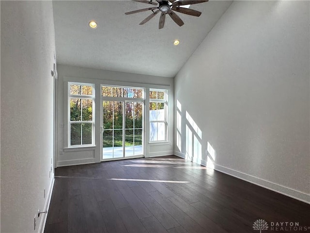 unfurnished living room featuring ceiling fan, dark hardwood / wood-style floors, and high vaulted ceiling