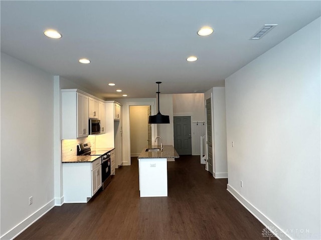 kitchen featuring backsplash, sink, hanging light fixtures, appliances with stainless steel finishes, and white cabinets