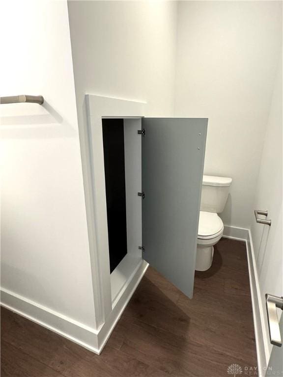 bathroom featuring hardwood / wood-style flooring and toilet