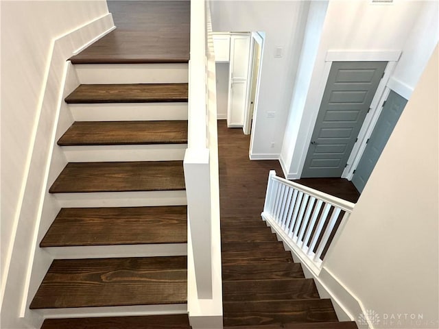 stairway featuring wood-type flooring