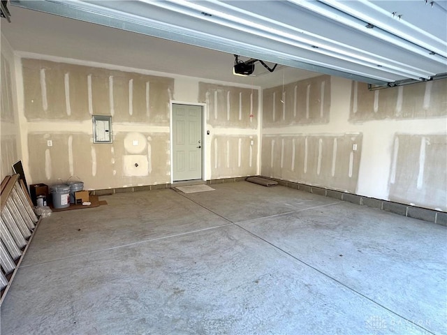 garage with electric panel and a garage door opener