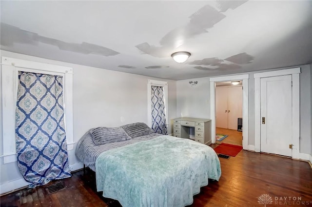 bedroom featuring dark hardwood / wood-style flooring