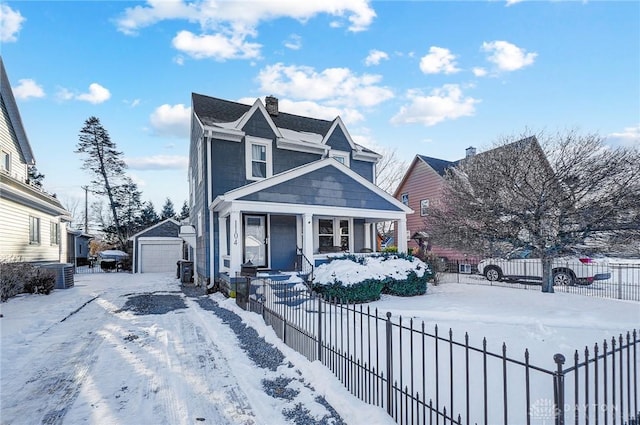 view of front of property featuring central AC unit, covered porch, a garage, and an outbuilding