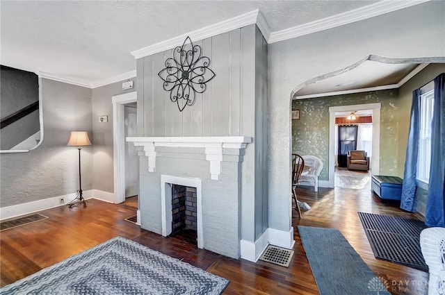 living room featuring a fireplace, dark hardwood / wood-style flooring, and ornamental molding