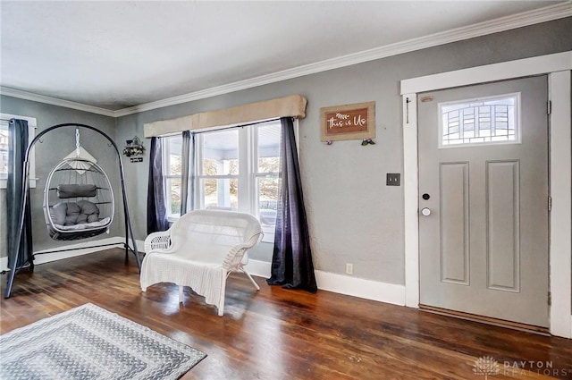 foyer entrance with dark wood-type flooring and ornamental molding