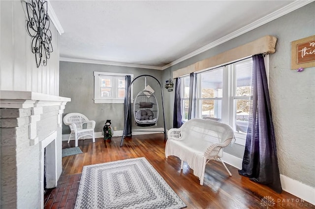 living area featuring plenty of natural light, a stone fireplace, and ornamental molding