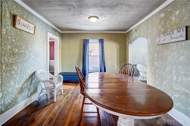 dining area featuring a textured ceiling, crown molding, and hardwood / wood-style flooring