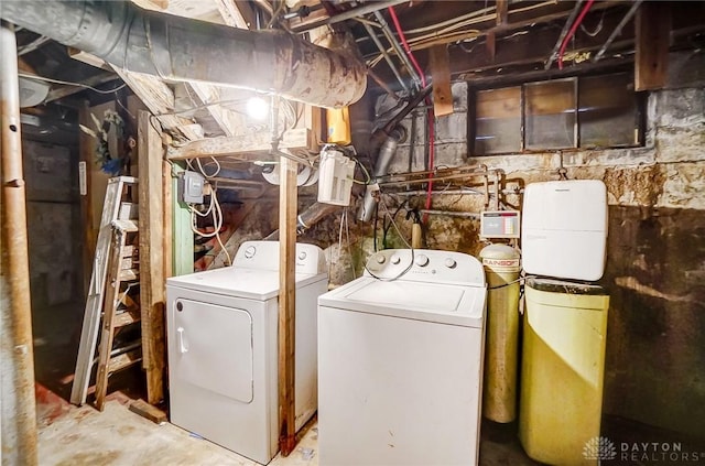 clothes washing area featuring separate washer and dryer