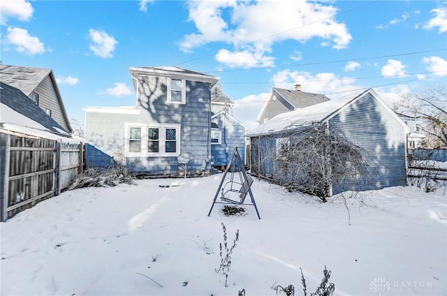 view of snow covered rear of property