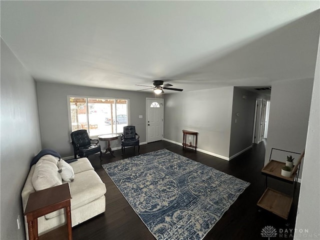 living room with dark wood-type flooring and ceiling fan