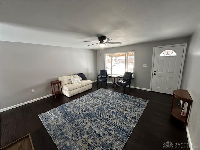 living room with ceiling fan and dark wood-type flooring