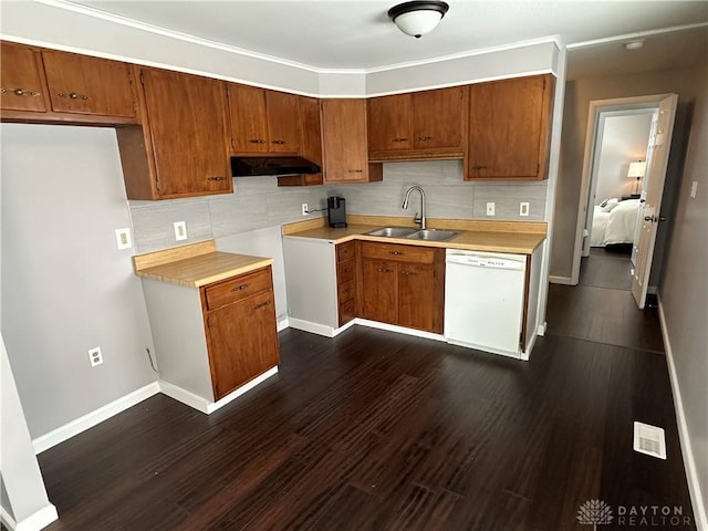 kitchen with dark hardwood / wood-style flooring, white dishwasher, tasteful backsplash, and sink