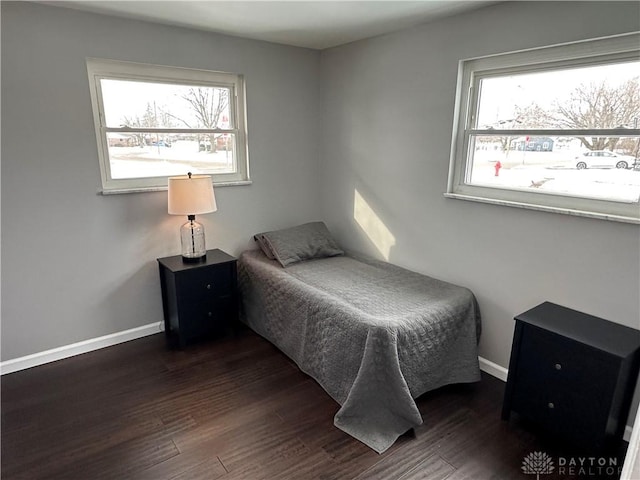 bedroom featuring dark wood-type flooring and multiple windows