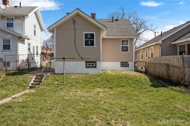 back of house with a lawn