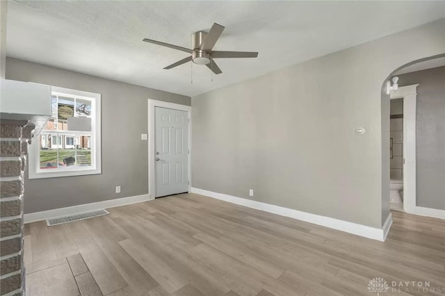 unfurnished room with ceiling fan, a textured ceiling, and light hardwood / wood-style flooring