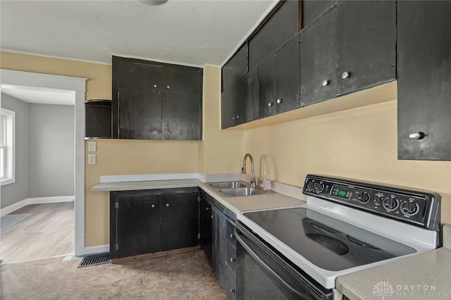 kitchen featuring sink, light carpet, and range with electric cooktop