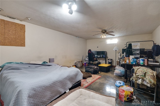 bedroom with a textured ceiling, ceiling fan, and concrete floors