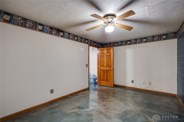 unfurnished room with ceiling fan and a textured ceiling