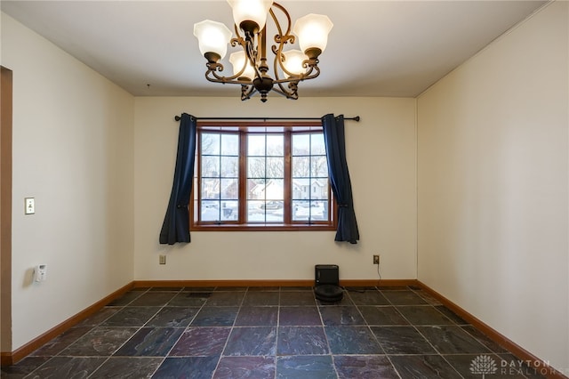 empty room featuring a chandelier