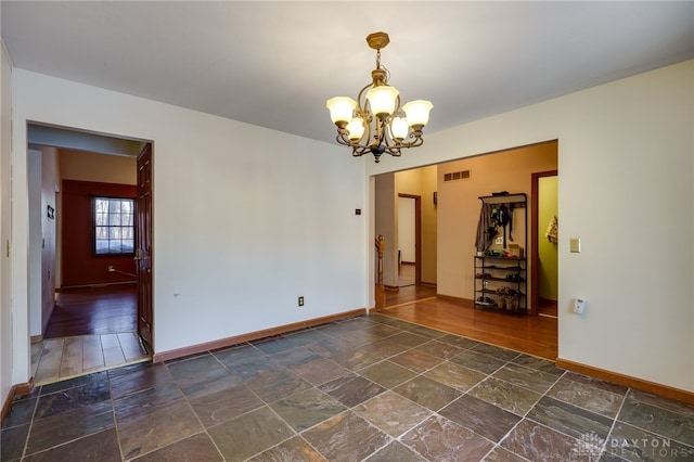 spare room with an inviting chandelier