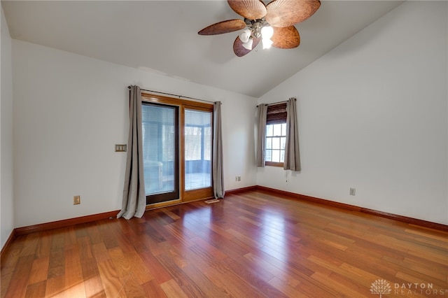 unfurnished room with ceiling fan, hardwood / wood-style flooring, and vaulted ceiling