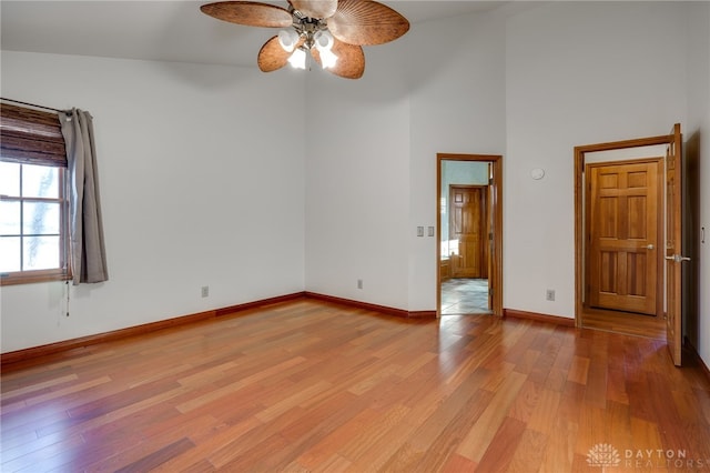 spare room with ceiling fan and light wood-type flooring