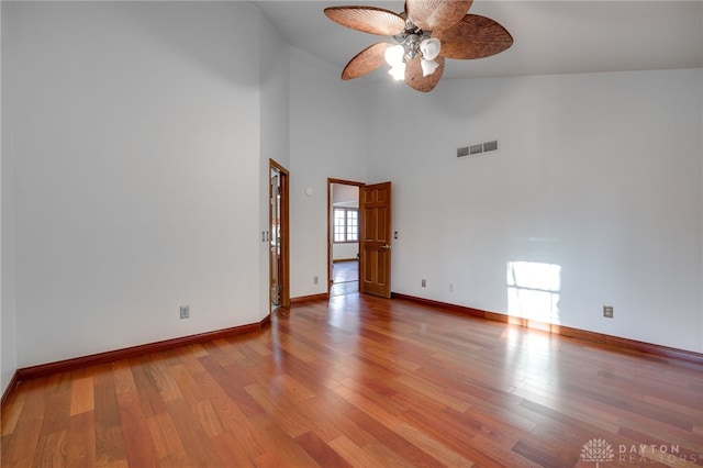 unfurnished room featuring high vaulted ceiling, light hardwood / wood-style floors, and ceiling fan