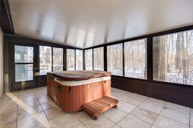 unfurnished sunroom featuring a hot tub