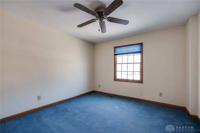 spare room with ceiling fan and carpet