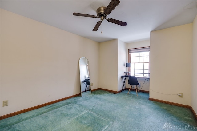 spare room featuring ceiling fan and carpet flooring