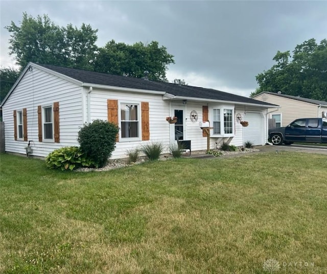 ranch-style house with a garage and a front lawn