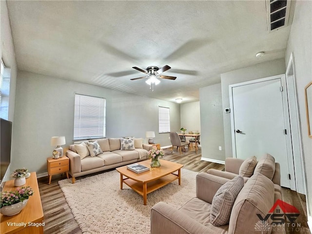 living room featuring ceiling fan and wood-type flooring